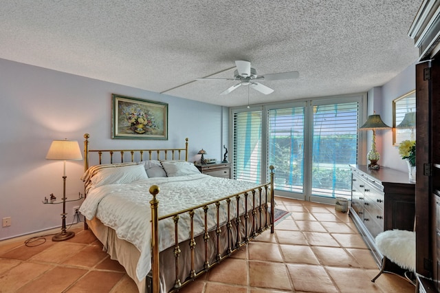 tiled bedroom with access to outside, ceiling fan, and a textured ceiling