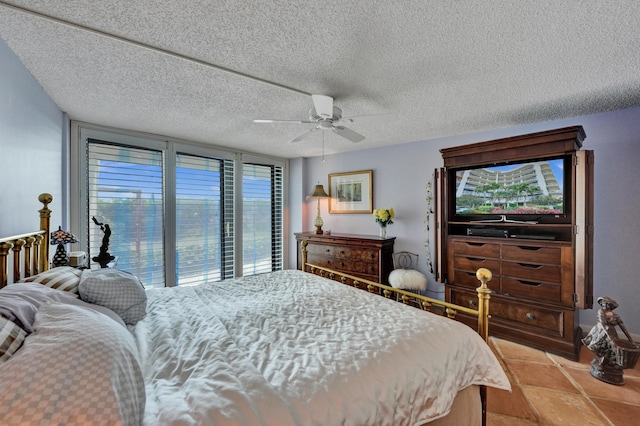 bedroom featuring a textured ceiling, ceiling fan, access to outside, and light tile floors