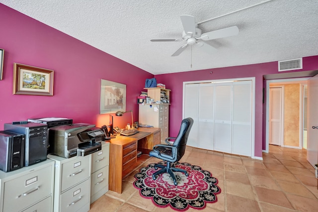 office space featuring ceiling fan, light tile flooring, and a textured ceiling