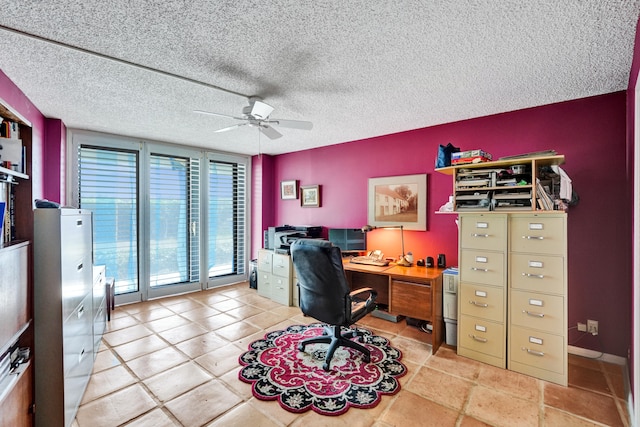 office with a textured ceiling, ceiling fan, and light tile flooring