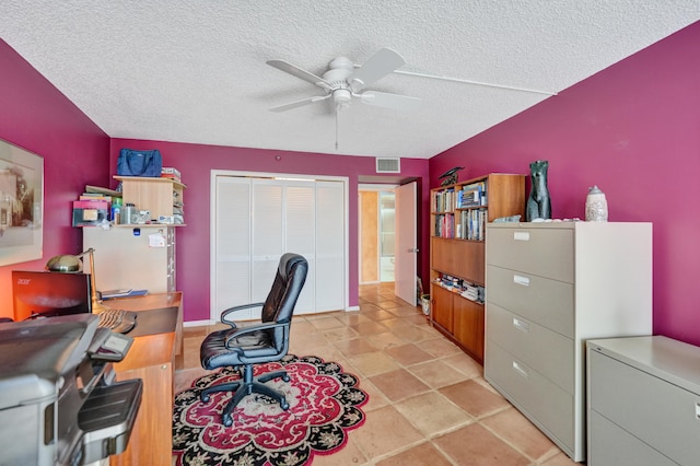 tiled home office with a textured ceiling and ceiling fan