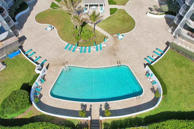 view of pool featuring a lawn