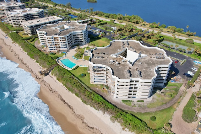 drone / aerial view featuring a water view and a beach view