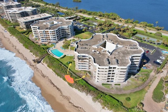 birds eye view of property featuring a view of the beach and a water view