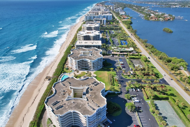 drone / aerial view featuring a water view and a beach view