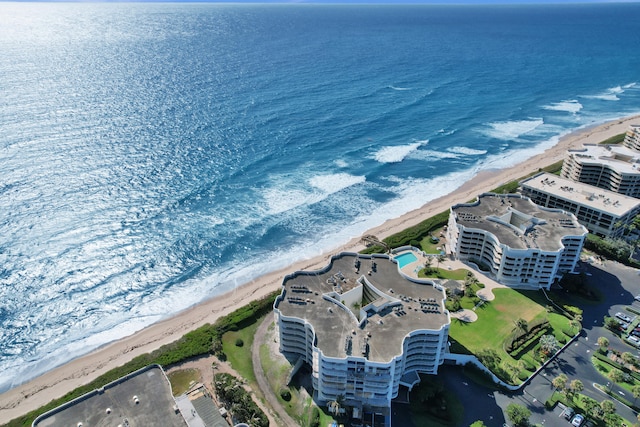 birds eye view of property featuring a beach view and a water view