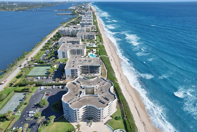 birds eye view of property with a water view and a beach view