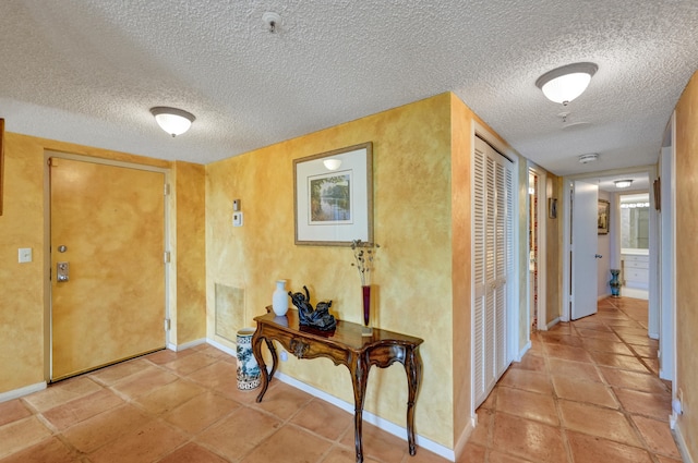 tiled entrance foyer with a textured ceiling