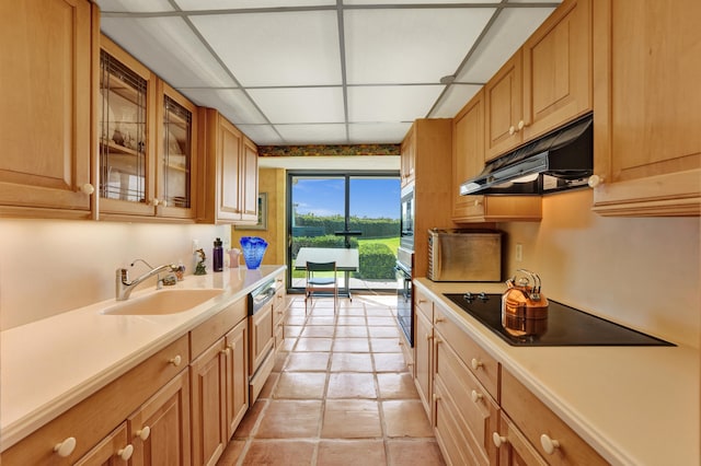 kitchen featuring sink, appliances with stainless steel finishes, light tile floors, and a paneled ceiling