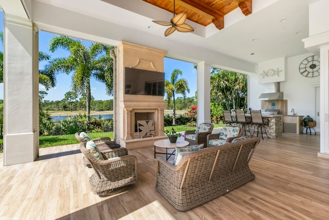 view of patio featuring a wet bar, a grill, and an outdoor kitchen