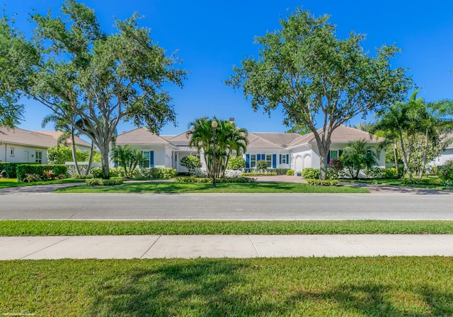 ranch-style house with a front lawn