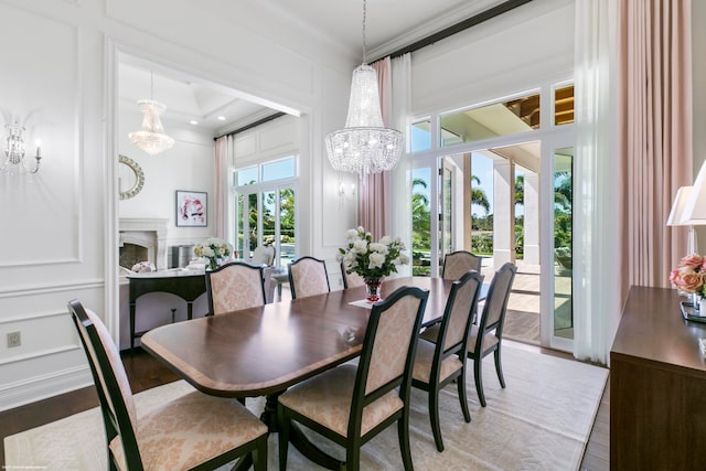 dining room featuring a chandelier, ornamental molding, and hardwood / wood-style floors