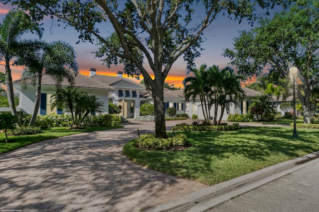 view of exterior entry featuring a lawn