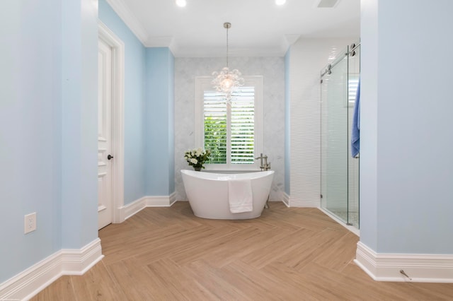 bathroom with parquet flooring, independent shower and bath, crown molding, and an inviting chandelier