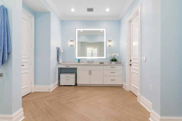 bathroom with parquet flooring, crown molding, and large vanity