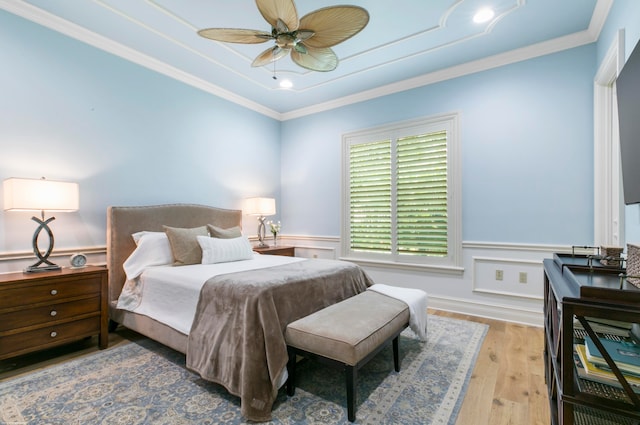 bedroom with ornamental molding, light hardwood / wood-style floors, and ceiling fan