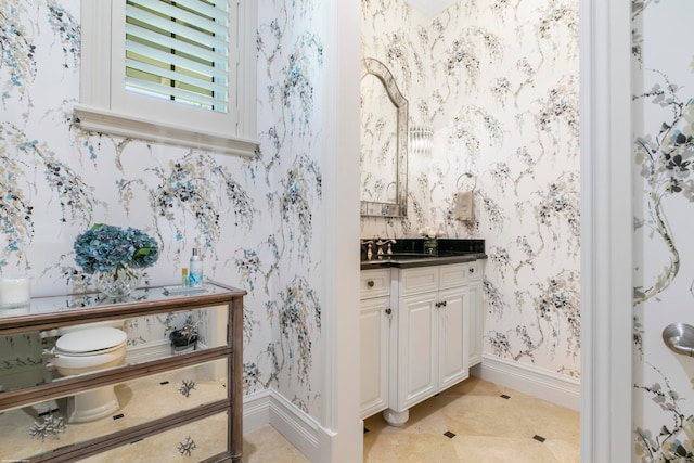 bathroom featuring vanity, tile floors, and toilet