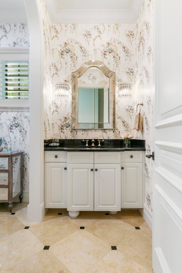 bathroom with crown molding, vanity, and tile floors