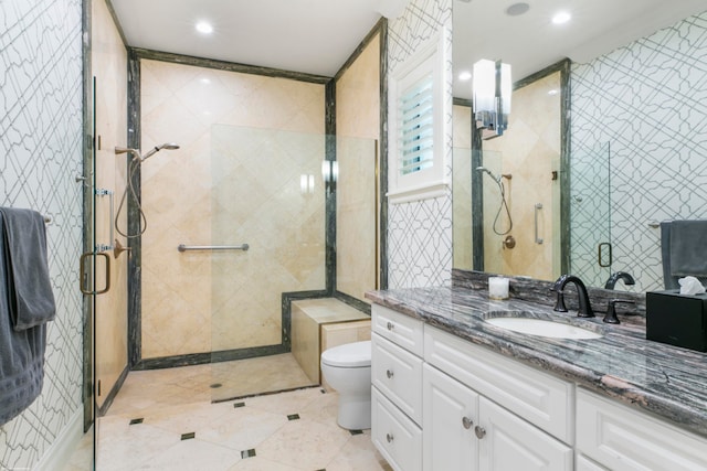 bathroom featuring tile walls, a shower with door, toilet, tile flooring, and vanity