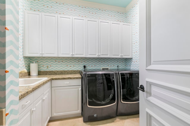 laundry room featuring independent washer and dryer and cabinets