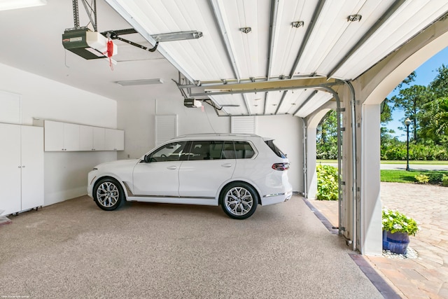 garage featuring a carport and a garage door opener