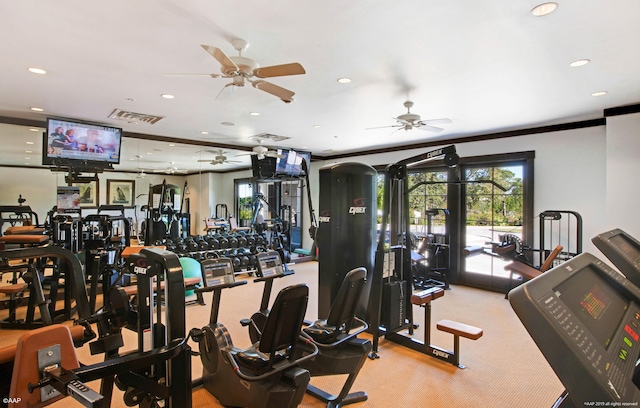 workout area with ceiling fan, light carpet, and ornamental molding