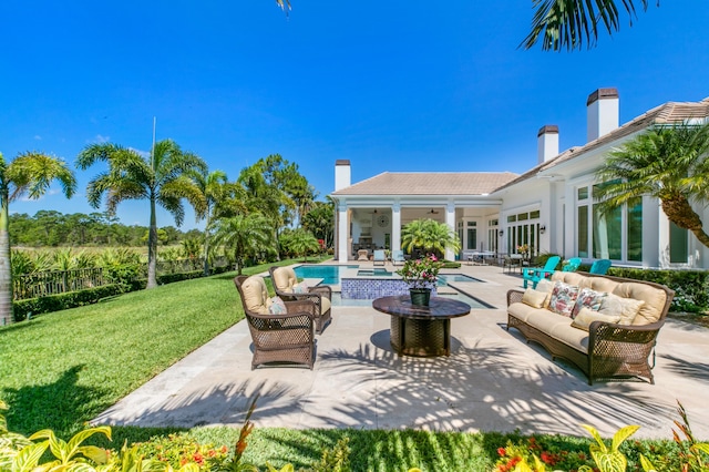 view of swimming pool with outdoor lounge area, an in ground hot tub, and a patio