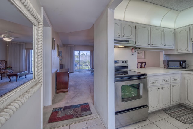 kitchen featuring light carpet, ceiling fan, and stainless steel electric range oven