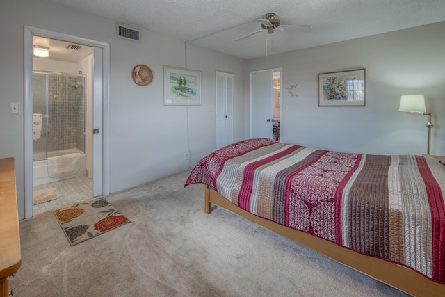 carpeted bedroom with connected bathroom, ceiling fan, and a textured ceiling