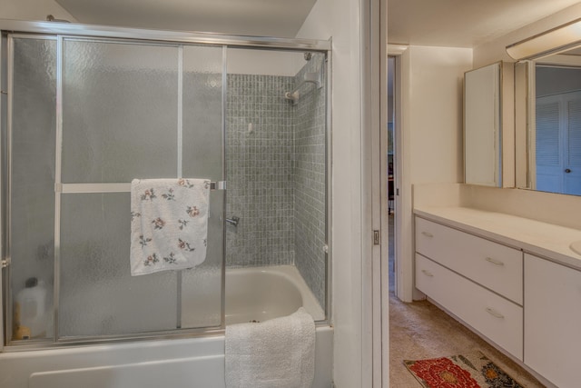 bathroom with vanity and enclosed tub / shower combo