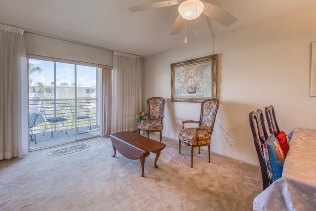 sitting room featuring ceiling fan and carpet flooring