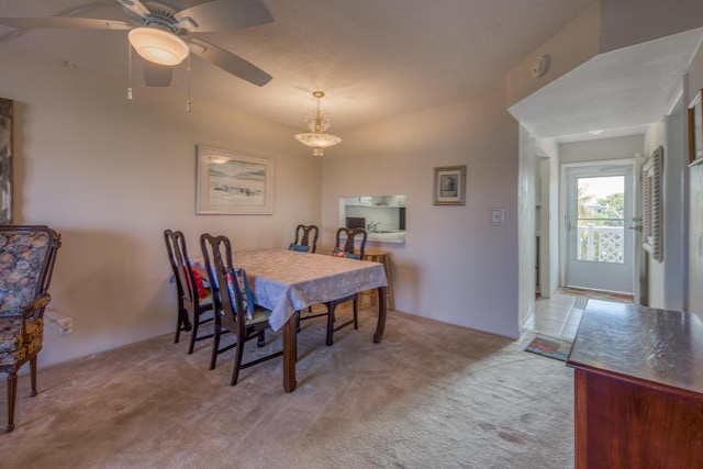 dining space featuring ceiling fan and carpet floors