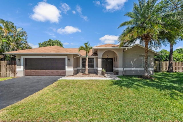 view of front of house featuring a front lawn and a garage