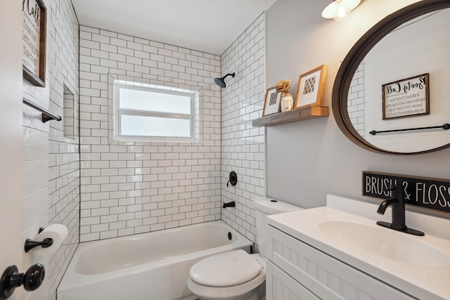 full bathroom featuring tiled shower / bath combo, vanity, and toilet