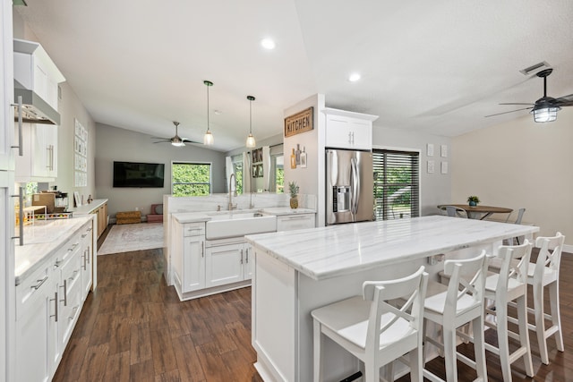 kitchen featuring dark hardwood / wood-style floors, ceiling fan, and stainless steel fridge