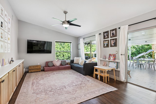 living room featuring ceiling fan, dark hardwood / wood-style floors, and vaulted ceiling