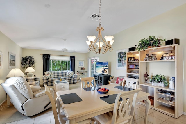 dining space featuring ceiling fan with notable chandelier and light tile floors