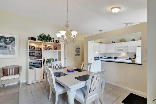 dining room with a chandelier and light tile floors