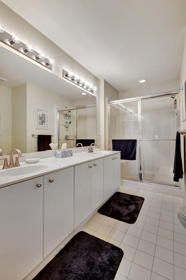 bathroom with walk in shower, tile floors, double sink, oversized vanity, and toilet