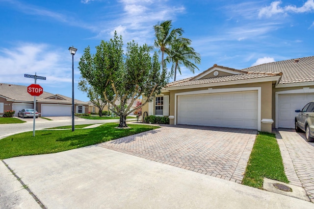 single story home with a garage and a front yard