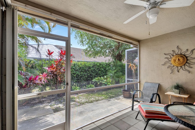 sunroom featuring ceiling fan