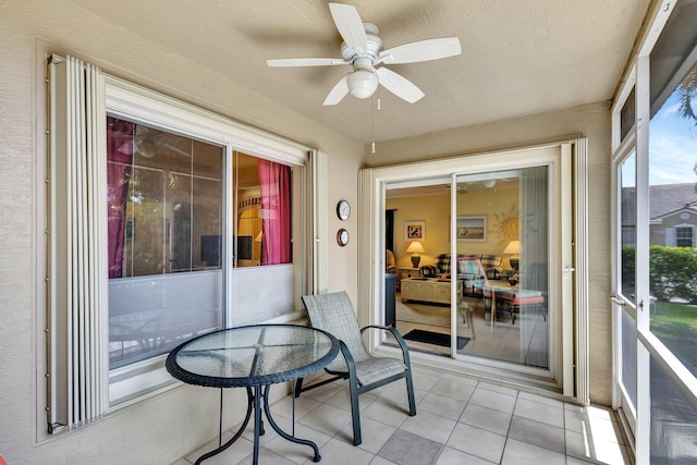 sunroom featuring ceiling fan