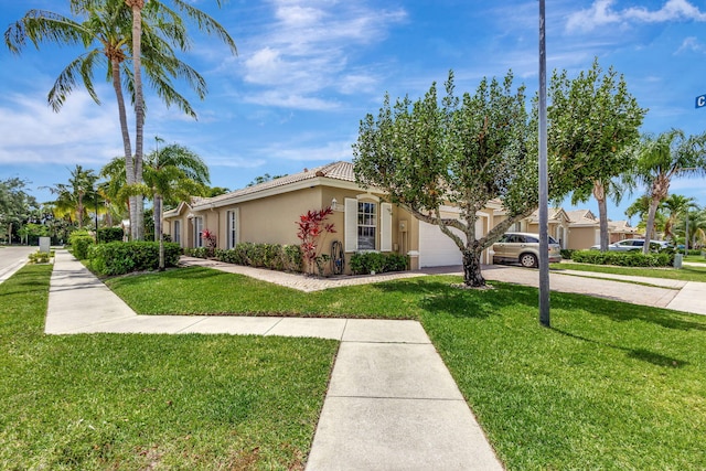 view of front of property with a front lawn and a garage