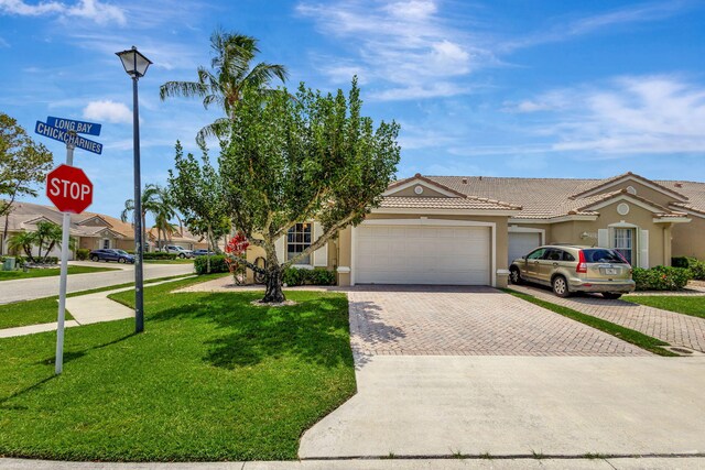 view of front of property with a garage and a front yard