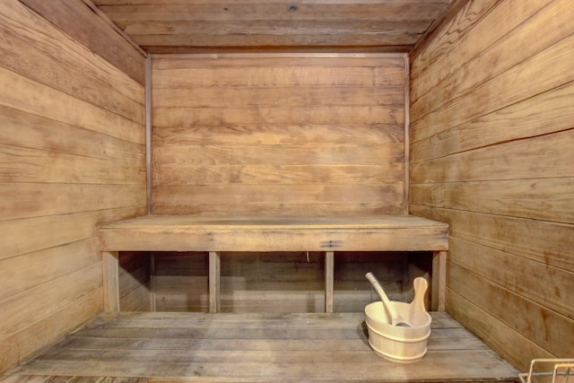 view of sauna with wooden ceiling, wooden walls, and hardwood / wood-style flooring