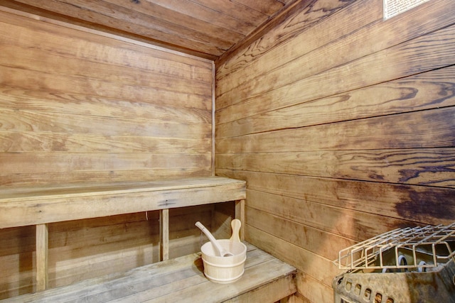 view of sauna / steam room with wooden walls and wood ceiling