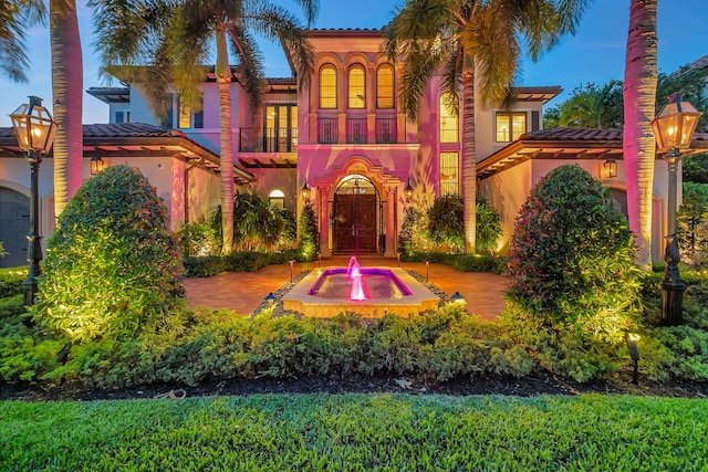 mediterranean / spanish-style home featuring a balcony