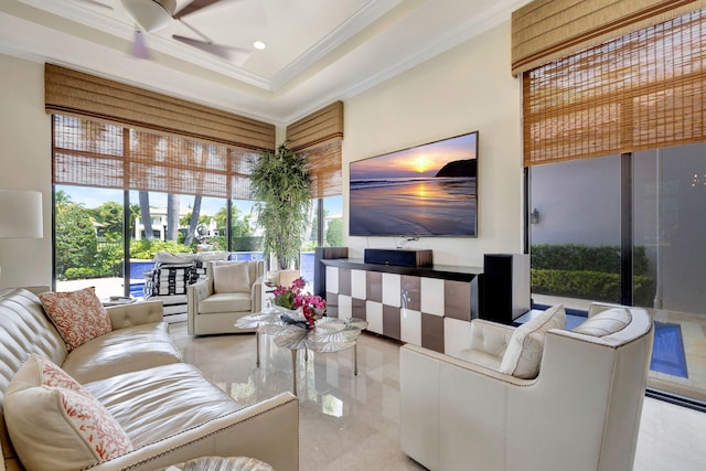 tiled living room with ceiling fan and ornamental molding