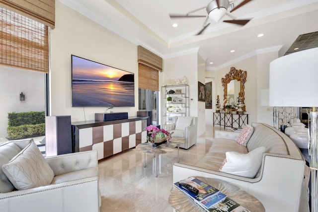 tiled living room featuring ornamental molding, ceiling fan, and a tray ceiling