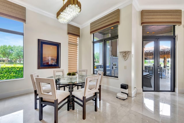 tiled dining area featuring a wealth of natural light, crown molding, french doors, and a chandelier